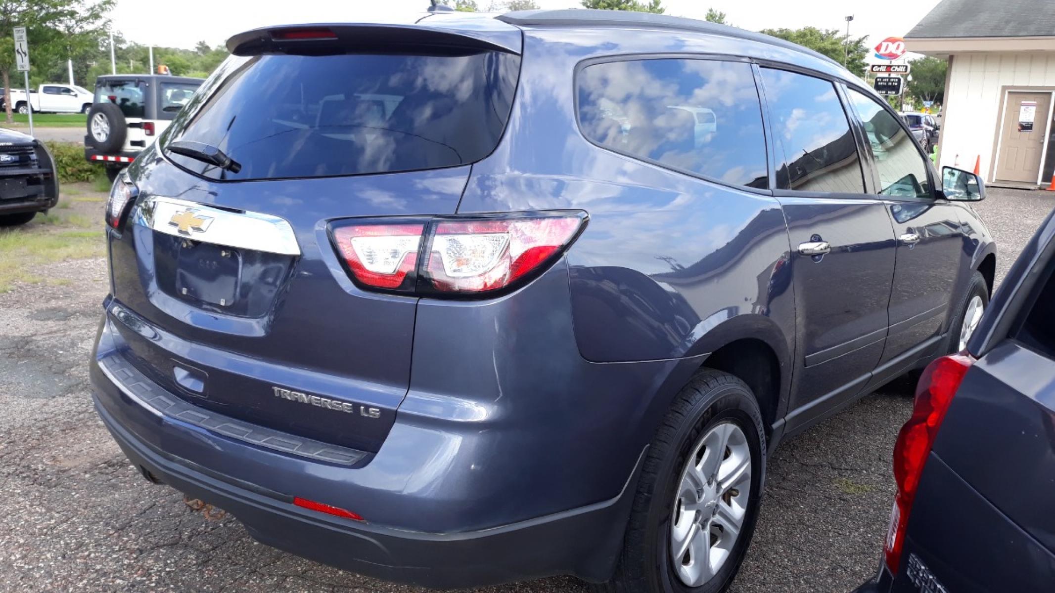 2014 Electronic Blue /GRAY Chevrolet Traverse LS FWD w/PDC (1GNKRFEDXEJ) with an 3.6L V6 DOHC 24V engine, 6-Speed Automatic transmission, located at 434 West Main Street, Anoka, MN, 55303, (763) 576-9696, 45.201759, -93.396706 - 3RD ROW SEAT!! 4 OWNER / NO ACCIDENTS MULTI-POINT "PERFORMANCE" INSPECTION PERFORMED: Transmission/clutch, Engine performance, Brakes, Steering, Heater/Air Conditioning, Instruments/Controls, Headlights/fog lights, Brake/back-up lights, Interior/warning lights, Turn signals/flashers MULTI-PO - Photo #4